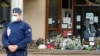 Flowers are stacked outside the school where slain history teacher Samuel Paty was working, in Conflans-Sainte-Honorine, northwest of Paris, France, Oct. 17, 2020.