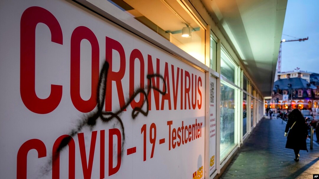 A woman walk next to an abandoned COVID-19 testing center in Frankfurt, Germany, Nov. 2, 2021