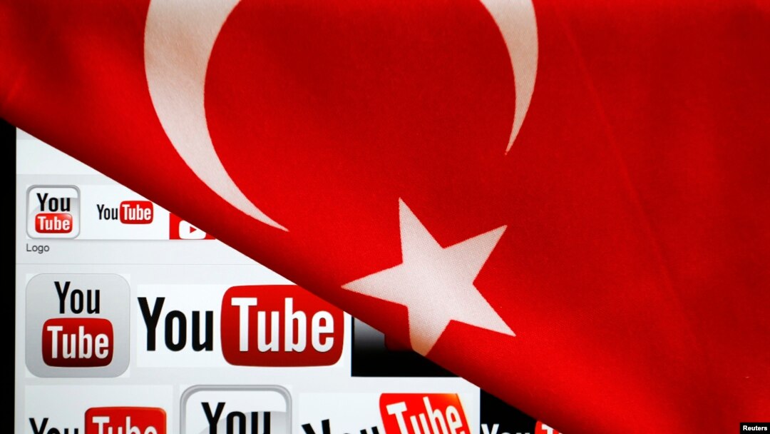 FILE - YouTube logos displayed on a laptop screen partially covered with Turkey's national flag in this photo illustration taken in Ankara, March 27, 2014. 