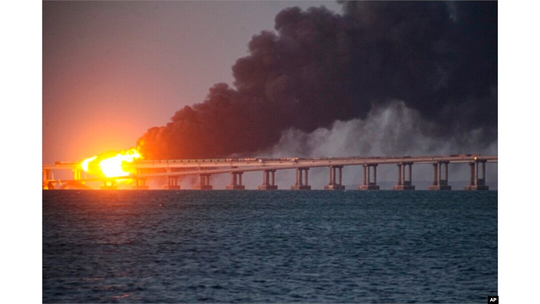 Flame and smoke rise from the Crimean bridge connecting the Russian mainland and the Crimean peninsula over the Kerch Strait, in Kerch, Crimea, Oct. 8, 2022.