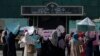 Afghan women hold placards as they take part in a protest in front of the Iranian embassy in Kabul, Sept. 29, 2022.