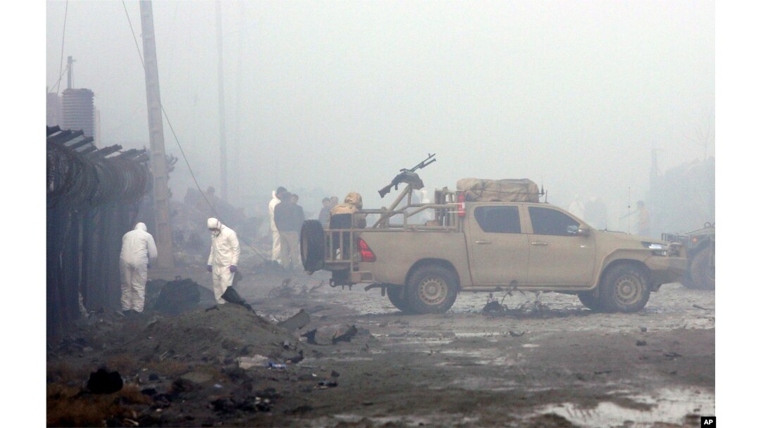 FILE - Security forces inspect the site of a suicide bomb attack in Kabul, Afghanistan, Nov. 29, 2018. Taliban insurgents staged a deadly coordinated attack targeting a British security firm in the Afghan capital Wednesday.