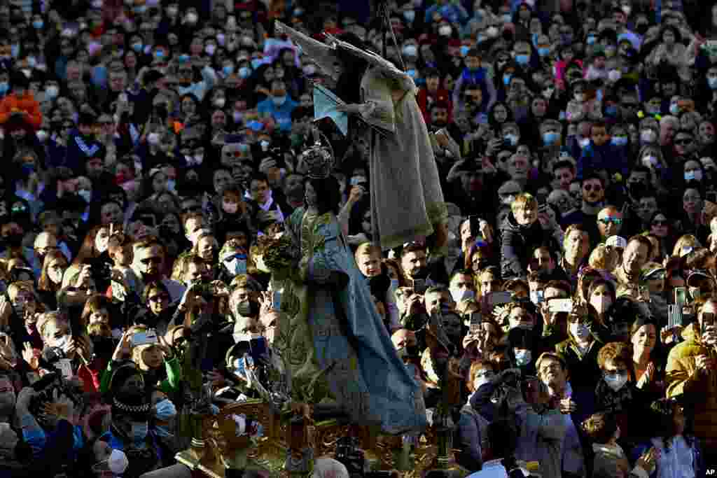 7-year-old Veronica Serrano, secured by a harness, is transported in the air as she unveils the face of a statue of the Virgin Mary during the Easter Sunday ceremony &#39;&#39;Descent of the Angel&#39;&#39;, part of Holy Week in Tudela, northern Spain.