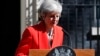 British Prime Minister Theresa May reacts as she turns away after making a speech in the street outside 10 Downing Street in London, England, May 24, 2019. 