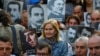 FILE - Human rights activists hold portraits of victims during a demonstration to commemorate the 1915 mass killing of Armenians in the Ottoman Empire, in central Istanbul, Turkey, Apr. 24, 2018. 