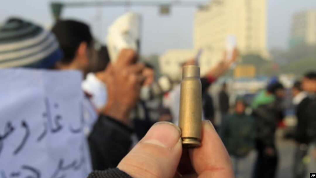 An Egyptian protester shows a spent cartridge casing during a demonstration at Tahrir Square in Cairo, December 19, 2011.