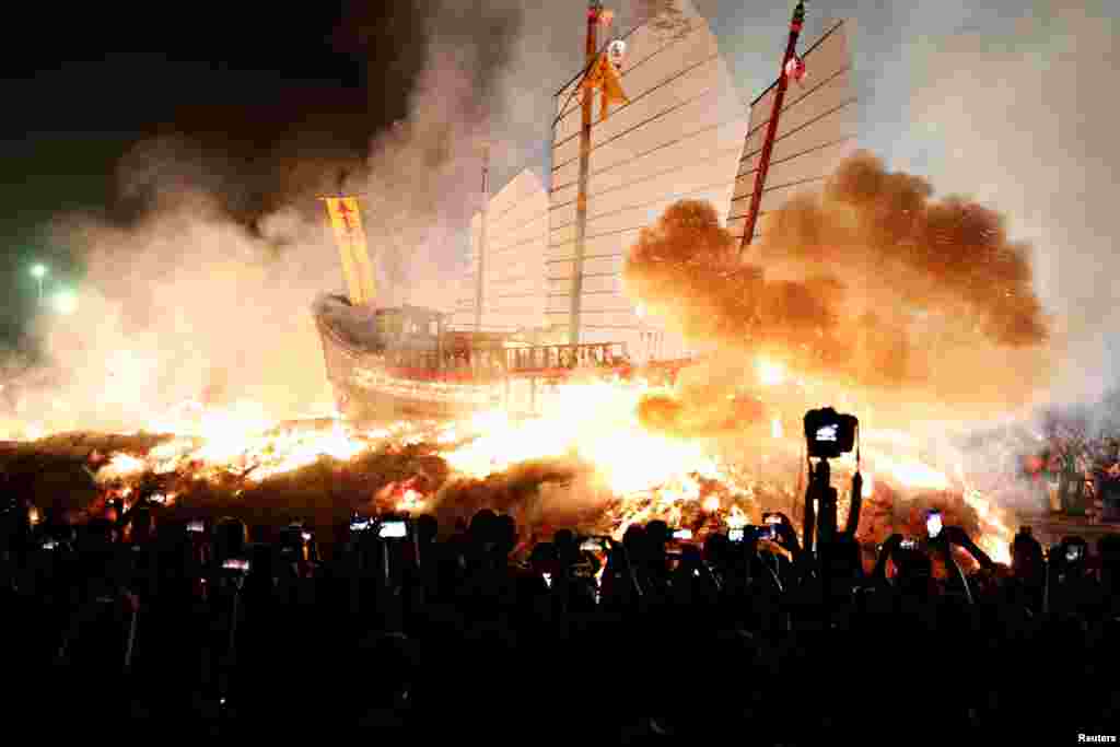 'Wang Yeh's Boat', a 13-meter finely crafted ancient warship made of paper and wood, sets on fire to ward off evil, disease and bad luck during Wang Yeh Boat Burning Festival, in Pingtung, Taiwan.