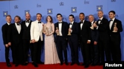 FILE - The cast and crew of "La La Land" pose after winning the award for Best Motion Picture - Musical or Comedy among other awards backstage during the 74th Annual Golden Globe Awards in Beverly Hills, California, Jan. 8, 2017.