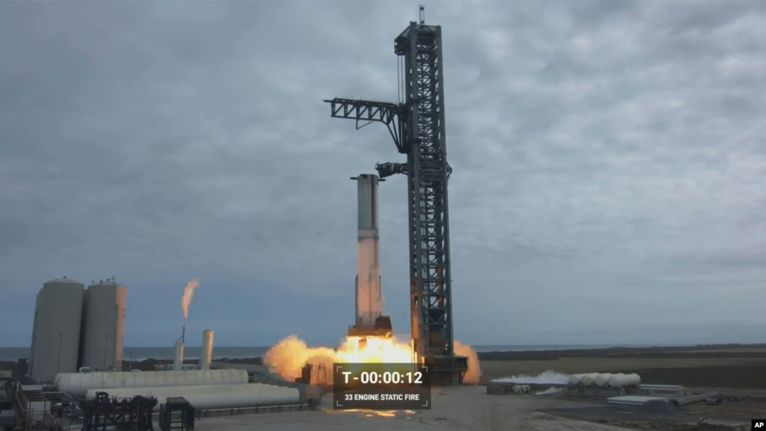 In this image from video made available by SpaceX, a Starship first-stage Super Heavy booster performs an engine-firing test at the launch pad in Boca Chica, Texas, Feb. 9, 2023. 