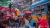 Laborers unload sealed sacks of spices at a wholesale market in Kolkata on Feb. 1, 2023.