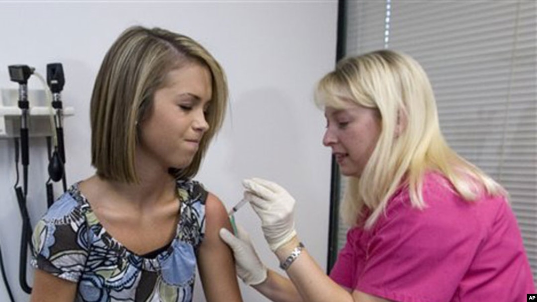 Lauren Fant, left, 18, winces as she has her third and final application of the HPV vaccine administered by nurse Stephanie Pearson at a doctor's office Tuesday, Dec. 18 2007, in Marietta, Ga. This groundbreaking vaccine that prevents cervical cancer in g