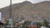 Afghan security forces inspect the site of a bomb explosion in Kabul, Afghanistan, May 18, 2020. A suicide bomber in a stolen military Humvee targeted a base of the country's intelligence service in Ghazni province.
