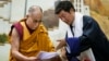 Lobsang Sangay, prime minister of the Tibetan government-in-exile, right, presents a document to spiritual leader the Dalai Lama at the Tibetan Children’s Village School in Dharmsala, India, June 5, 2014.