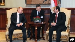FILE - Egyptian President Abdel-Fattah el-Sissi, right, talks to Russian President Vladimir Putin during their meeting in Cairo, Egypt, Feb. 9, 2015. 