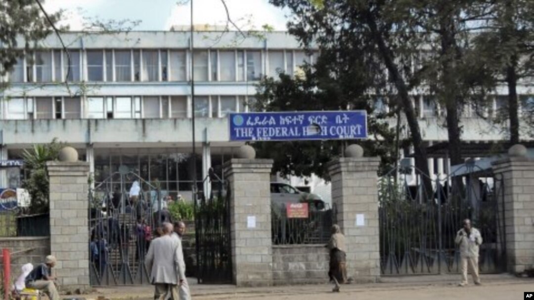 Pedestrians walk past the Federal High Court building in Addis Ababa, Ethiopia, November 1, 2011.