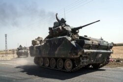 FILE - Turkish troops head to the Syrian border, in Karkamis, Turkey, Aug. 27, 2016.