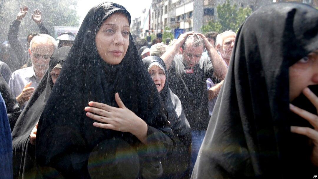 FILE - Iranians attend the funeral of victims of an Islamic State militant attack in Tehran, Iran, June 9, 2017.