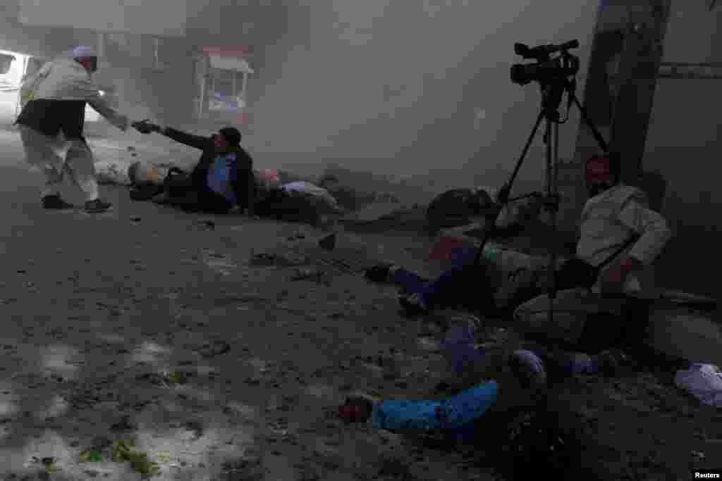 Afghan journalists are seen after a second blast in Kabul, Afghanistan, April 30, 2018.