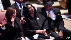Vice President Kamala Harris, left, sits with RowVaughn Wells and Rodney Wells during the funeral service for Wells' son, Tyre Nichols, at Mississippi Boulevard Christian Church in Memphis, Tenn., Feb. 1, 2023. (Andrew Nelles/The Tennessean via AP, Pool)