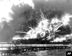 FILE - In this photo provided by the U.S. Navy, the destroyer USS Shaw explodes after being hit by bombs during the Japanese attack on Pearl Harbor, Hawaii, Dec. 7, 1941.