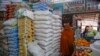 A woman walks past sacks of wheat flour piled high in the Hamar-Weyne market in the capital Mogadishu, Somalia, May 26, 2022. 