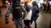 Riot police detain a demonstrator during a protest against mobilization in Moscow, Russia, Sept. 21, 2022.