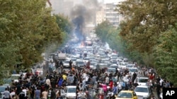 FILE - Demonstrators chant slogans during a protest over the death of a woman detained by the morality police, in downtown Tehran, Iran, Sept. 21, 2022, in this photo taken by an individual not employed by the Associated Press and obtained by the AP.