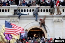 FILE - A mob of supporters of U.S. President Donald Trump storm the U.S. Capitol building in Washington, Jan. 6, 2021.