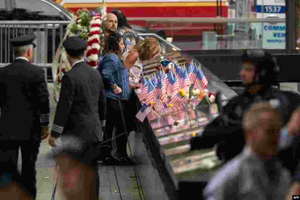 Relatives of the victims look at the 9/11 Memorial in New York City, Sept. 11, 2022, on the 21st anniversary of the attacks.