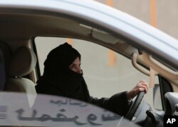 FILE - Aziza al-Yousef drives a car on a highway in Riyadh, Saudi Arabia, as part of a campaign to defy Saudi Arabia's ban on women driving, March 29, 2014.
