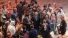 Abdullah Abdullah (C), Chairman of Afghanistan's High Council for National Reconciliation, speaks with members of delegations at the end of the session during the peace talks between the Afghan government and the Taliban in Doha, Sept. 12, 2020.
