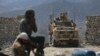 FILE - U.S. forces and Afghan security police are seen in Asad Khil near the site of a U.S. bombing in the Achin district of Jalalabad, east of Kabul, Afghanistan, April 17, 2017. 