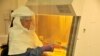 FILE - A medical worker from the U.S. Centers for Disease Control and Prevention working on the Ebola outbreak in Uganda.