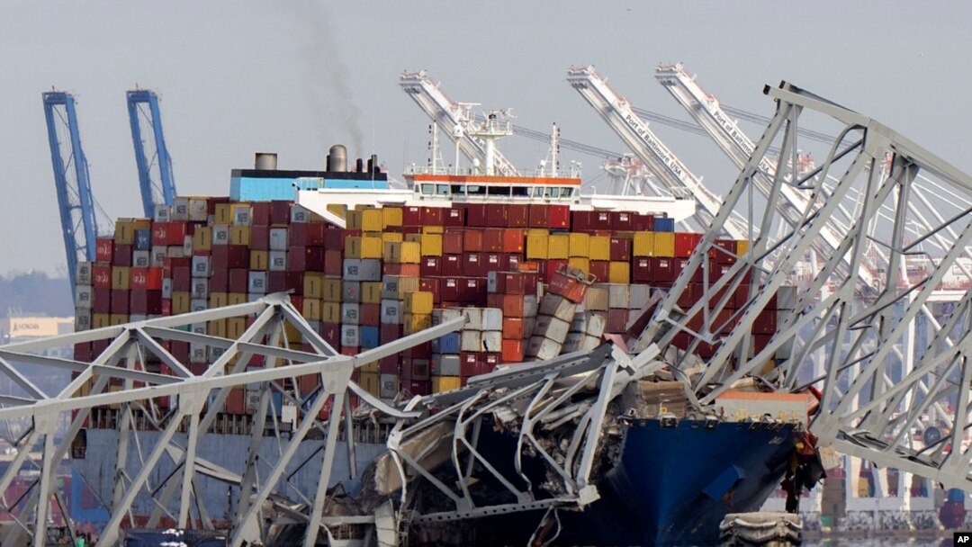FILE - The cargo ship Dali is stuck under part of the structure of the Francis Scott Key Bridge after the ship hit the bridge, March 26, 2024, as seen from Pasadena, Maryland.