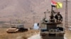 Hezbollah and Syrian flags flutter on a military vehicle in Western Qalamoun, Syria, Aug, 28, 2017.