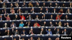 FILE - Members of the European Parliament take part in a voting session in Strasbourg, France, April 12, 2016.