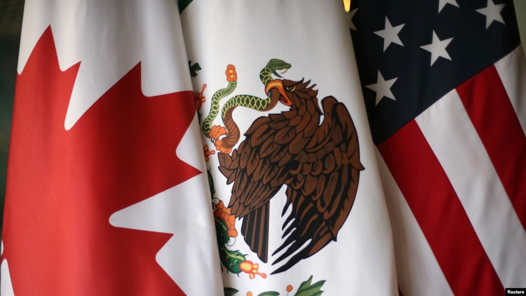 FILE - Flags are pictured during the fifth round of NAFTA talks involving the United States, Mexico and Canada, in Mexico City, Nov. 19, 2017. 