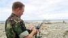 File -- Navy Chief Warrant Officer Paul Patterson calculates coordinates for a potential amphibious landing zone near Makuto, Venezuela, Jan. 3, 2000. 