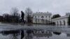 A reporter leaves the White House after the daily briefing, in Washington, Jan. 31, 2025.