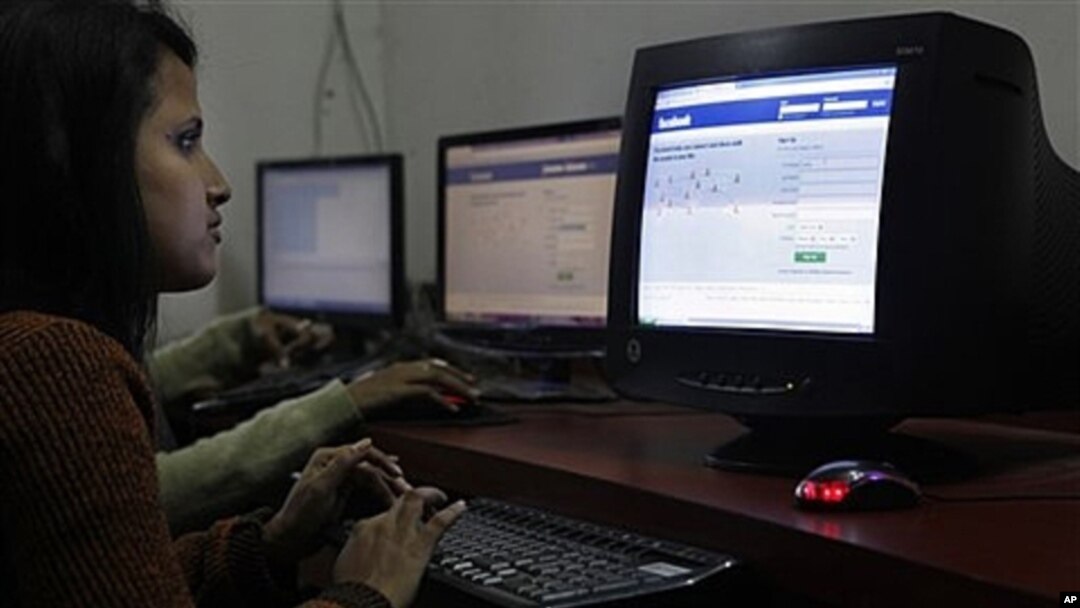 A girl surfs a Facebook page at an Internet cafe in Gauhati, India, Dec. 6, 2011.