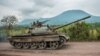 FILE - A Congolese army tank heads towards the front line near Kibumba in the area surrounding the North Kivu city of Goma during clashes between the Congolese army and M23 rebels, May 25, 2022.
