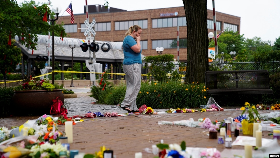 A woman reacts while visiting a memorial site after a mass shooting at a Fourth of July parade in the Chicago suburb of Highland Park, Illinois, July 6, 2022. 