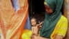 Amina Shuto, 21, holds her two-month old malnourished child at a makeshift camp for the displaced on the outskirts of Mogadishu, Somalia, on June 30, 2022. Since January, at least 200,000 children have died due to malnutrition in Somalia.