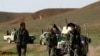 FILE - Afghan National Army soldiers (ANA) check the road before an operation at the Mir Abadi village of Adraskan district of Herat province, April 4, 2014. 