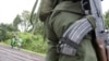 DRC army soldier watches civilians cross the front line with (CNDP) forces, near Goma, Dec. 2008.