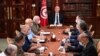 Tunisia's President Kais Saied, center, leads a security meeting with members of the army and police forces in Tunis, July 25, 2021. 