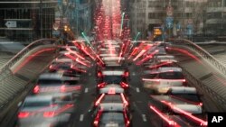 In this slow-shutter zoom effect photo taken Dec. 12, 2018, commuters backed up in traffic during the morning rush hour, in Brussels, a city that regularly experiences pollution alert warnings. 