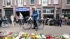 FILE PHOTO: A man looks on next to a makeshift altar at the place where Dutch celebrity crime reporter Peter R. de Vries was fatally shot in Amsterdam, Netherlands, July 7, 2021.