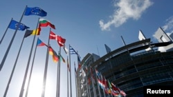 Flags of European Union member states fly in front of the European Parliament building in Strasbourg, France, April 15, 2014. 