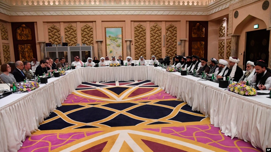 This photo released by Qatar's Ministry of Foreign Affairs shows Qatari, U.S. and Taliban officials conferring in an undisclosed place in Doha, Feb. 25, 2019, ahead of the latest round of talks with the insurgents aimed at ending the Afghan war.